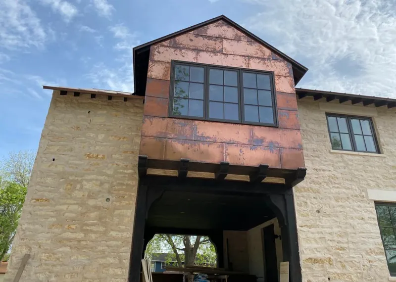 Copper metal panel facade on a stone building for Metal Roof Coating in Wichita